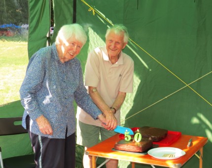 Cutting the cake marking 50 Summer camps